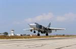 FILE - In this Oct.  3, 2015, file photo, a Russian  SU-24M jet fighter armed with laser guided bombs takes off from a runaway at Hmeimim airbase in Syria. Russia and the United States signed an agreement Oct. 20 designed to minimize the risk of collisions and other dangers as both countries carry out airstrikes in Syria. (Alexander Kots, Komsomolskaya Pravda, Photo via AP)